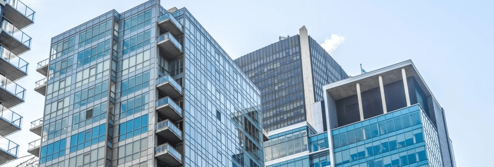 A building with many windows and balconies in the background.