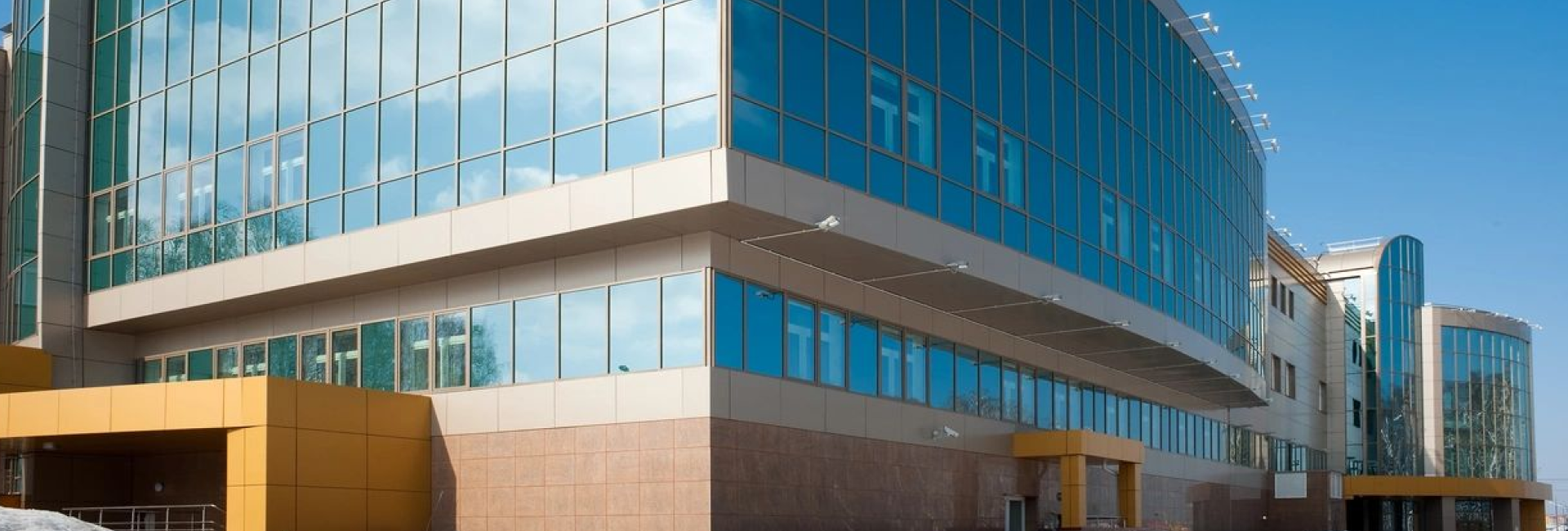 A building with many windows and a sky background